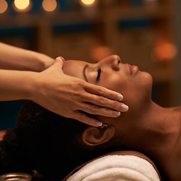 Relaxed woman having head massage